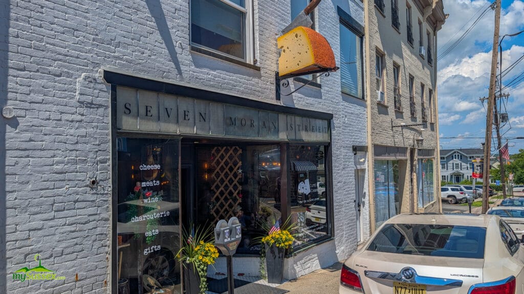 Exterior of Curd & Cleaver at 7 Moran Street in downtown Newton, NJ, with its large cheese-shaped storefront sign.