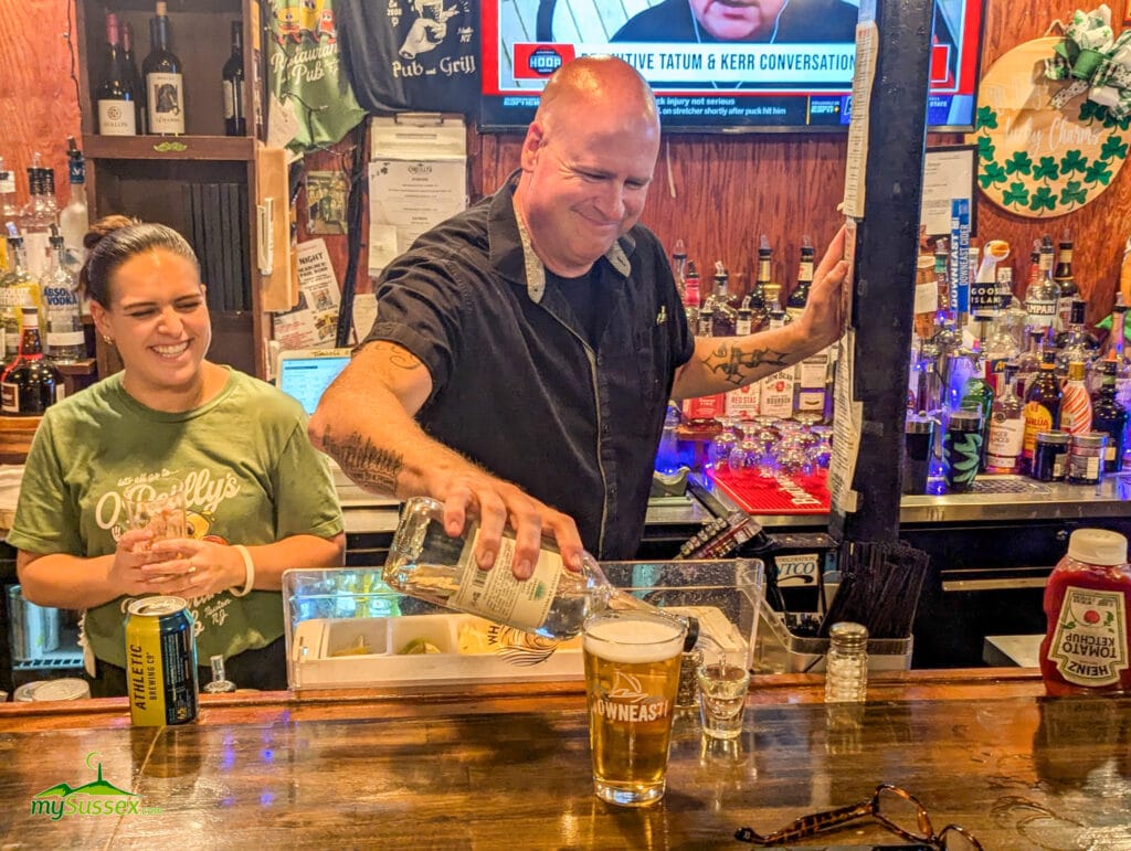 Bartender Ken pours a shot behind the bar beside a pint of beer at O’Reilly’s Pub & Grill in Newton, New Jersey.