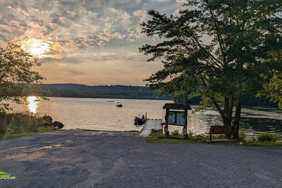 Boat approaching the launch on Swartswood Lake at sunset.
