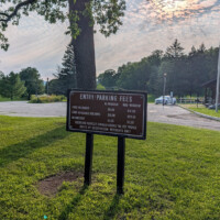 Entrance sign listing admission fees for Swartswood State Park.